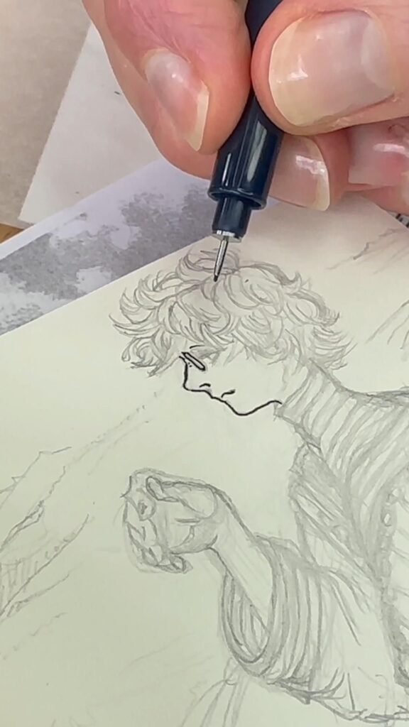 Close-up of a hand drawing an intricate sketch of a person with curly hair using a black ink pen on paper.