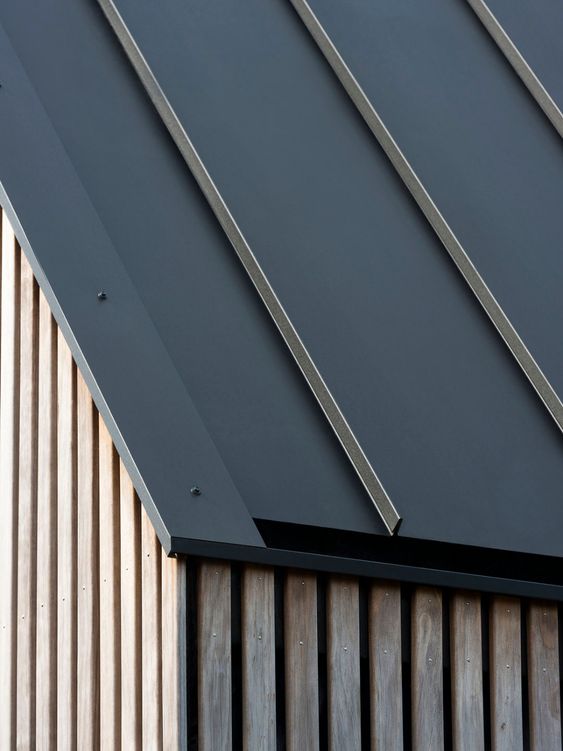 Modern architectural siding with metal paneling and wooden slats. Ideal for contemporary building design inspiration.