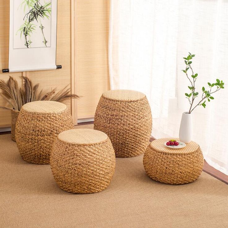 Stylish woven rattan stools and minimalistic décor in a serene, natural-toned living space with soft lighting.