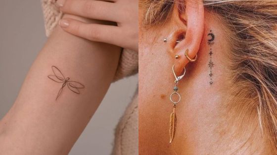 Minimalist dragonfly tattoo on a forearm and celestial tattoos behind an ear with multiple earrings and a feather charm.
