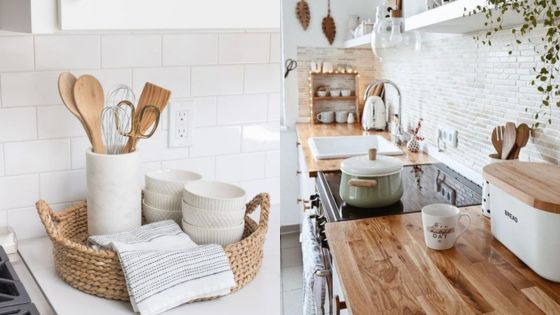 Modern white kitchen with wooden utensils, ceramic dishes, and potted plants. Bright and clean minimalist cooking space.