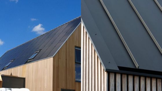 Modern wood-clad house with sleek metal roof panels under a clear blue sky. Sustainable architecture design.