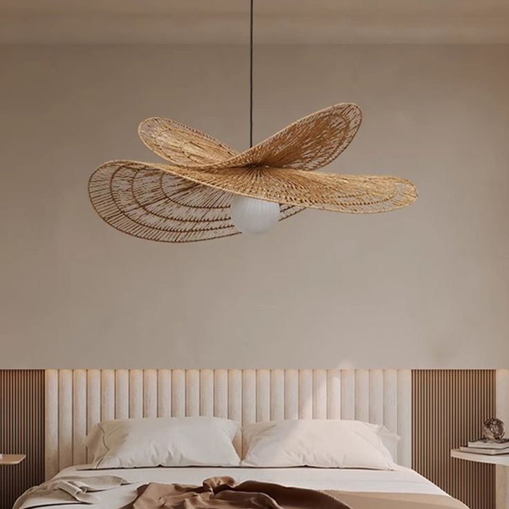 Modern bedroom with minimalist design featuring a unique woven rattan pendant light above a bed with white linens.