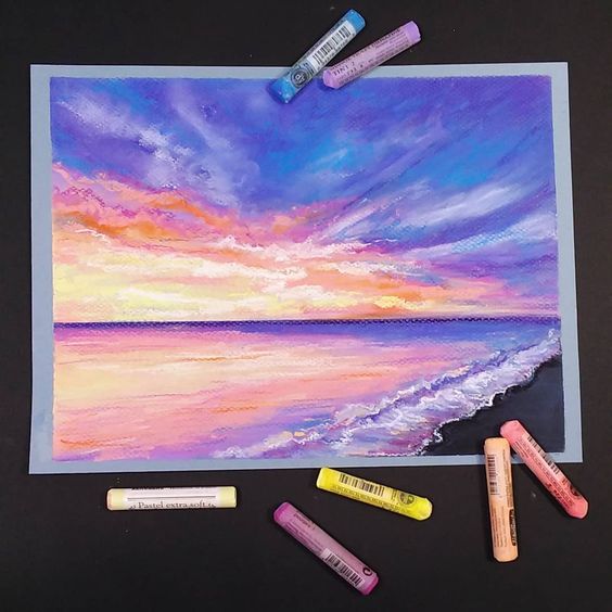 Colorful pastel sunset over ocean with beach waves, surrounded by pastel sticks on black background.