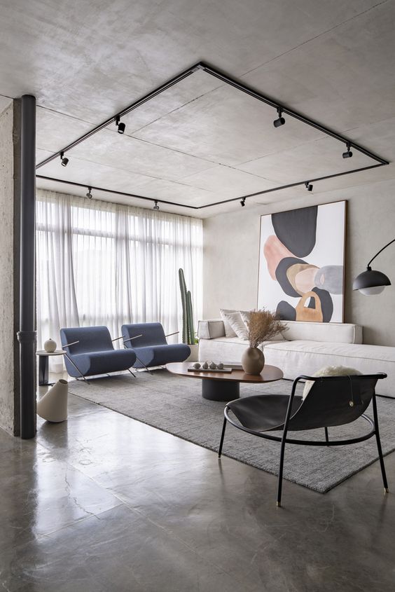 Modern living room with minimalist decor, blue chairs, abstract art, large window, and gray tones. Cozy and stylish interior.