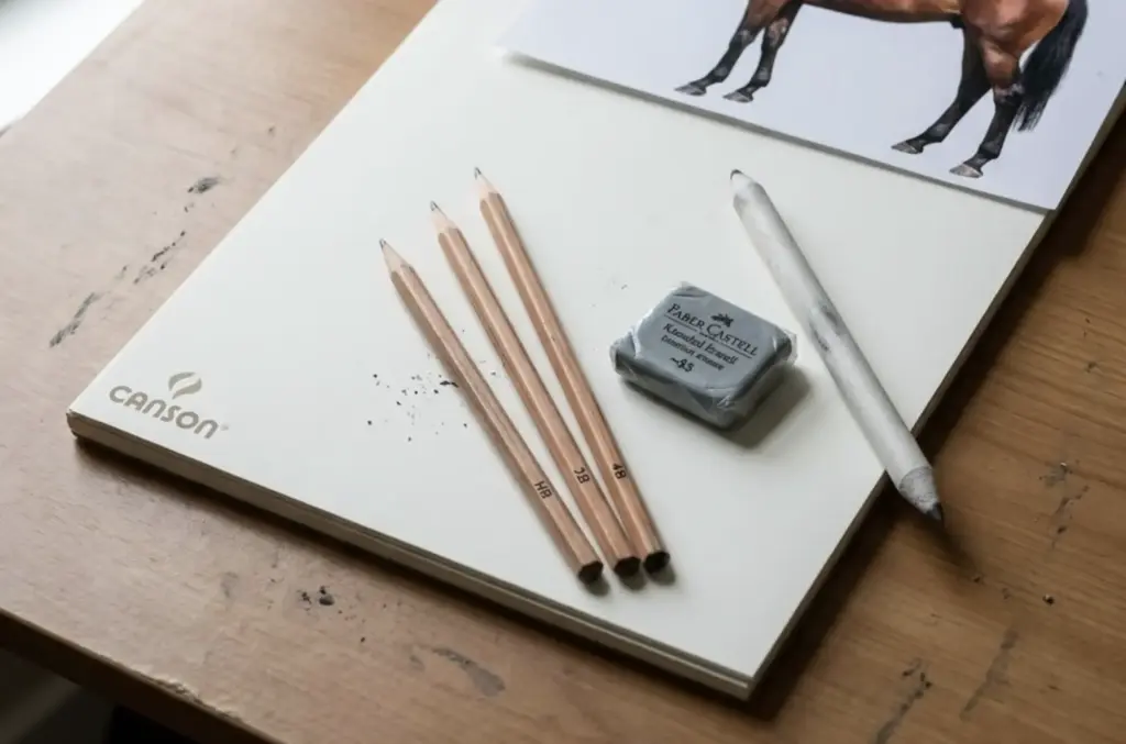 Canson sketchbook with three graphite pencils, Faber-Castell eraser, blending stump and horse drawing, artist supplies