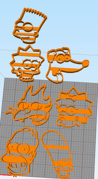 3D-printed cookie cutters of cartoon characters on a grid surface, including faces and outlines of each character.