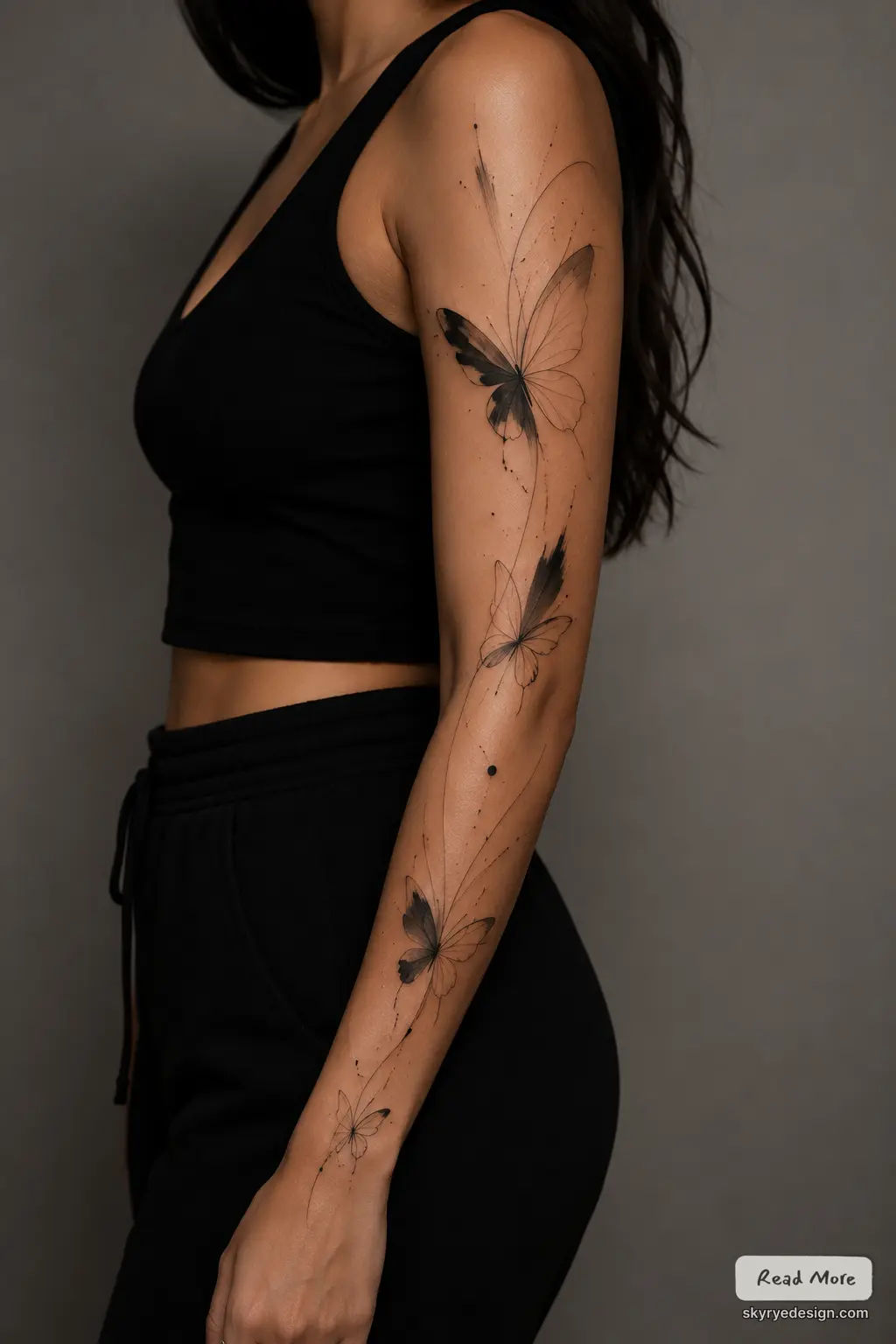 Black watercolor butterfly tattoo sleeve on woman's arm and forearm, delicate minimalist ink butterflies