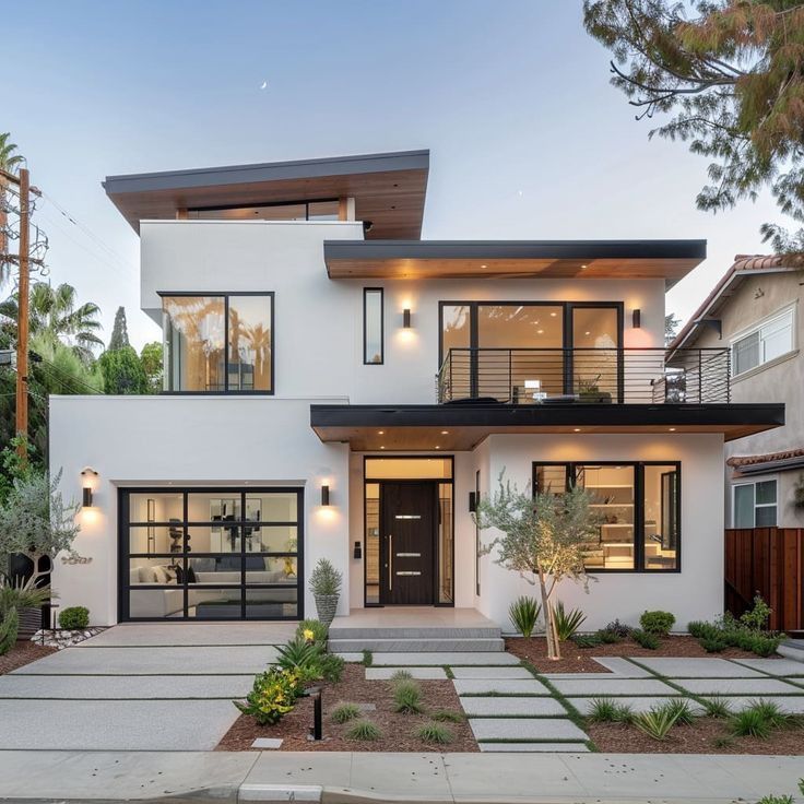 Modern two-story home with large windows, sleek exterior design, and manicured landscaping in a suburban neighborhood.