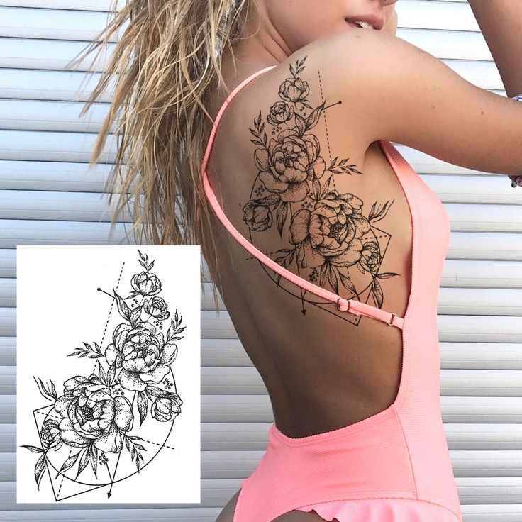 Woman in pink swimsuit showcases an intricate floral tattoo with geometric elements on her back and shoulder.