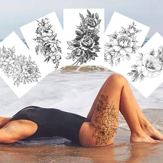 Woman in black swimsuit with floral thigh tattoo, lying on beach. Six detailed flower tattoo designs displayed above.