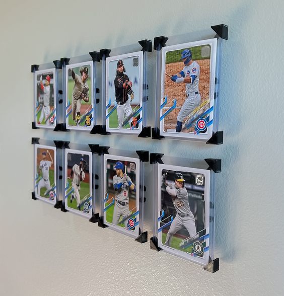 Wall display of nine baseball cards in protective holders, featuring various players in action poses.