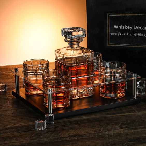 Elegant whiskey decanter set with crystal glasses on wooden table, perfect for sophisticated home bar setups.