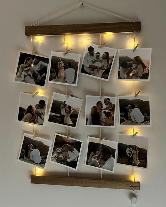 Decorative Polaroid photo display with fairy lights and family pictures hanging on a wall. Cozy and warm ambiance.