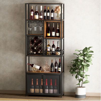 Modern wine rack with bottles, glasses, and decorations, next to a green potted plant, set against a minimalist wall background.