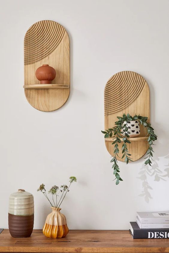 Minimalist wooden wall shelves with decorative vases and plants, a stylish addition to a modern home interior design.