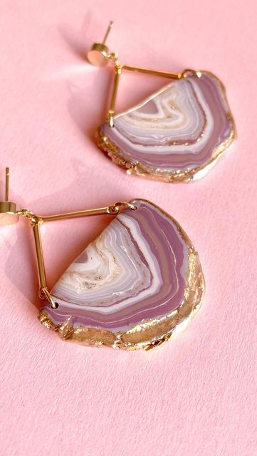 Stylish geode slice earrings with gold accents on pink background, perfect for trendy and elegant fashion accessories.