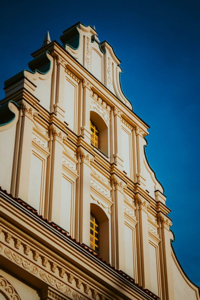 Historic European architecture with intricate detail on a building facade against a clear blue sky.