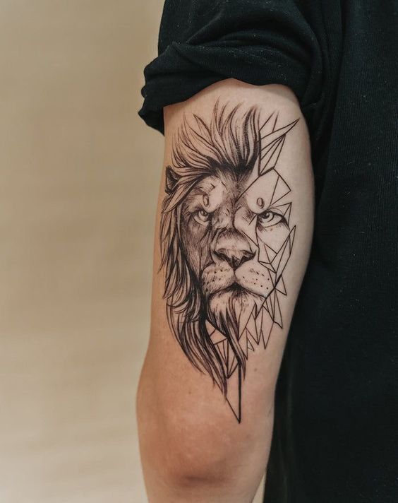 Detailed lion tattoo with geometric elements on male upper arm, displaying artistic blend of realism and abstraction.