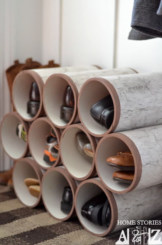 DIY shoe organizer made from repurposed PVC pipes stacked in a grid, showcasing an array of organized footwear.