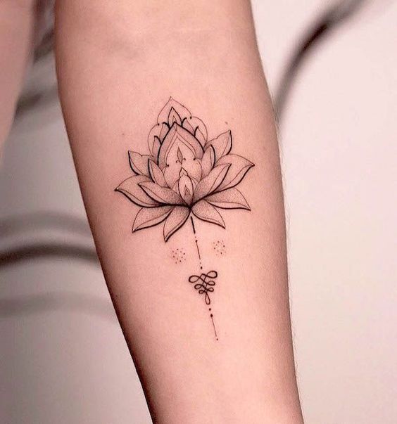 Minimalist lotus flower tattoo design on forearm with intricate details and fine line work.