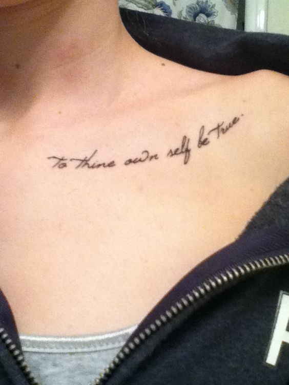 Tattoo on collarbone with cursive script saying To thine own self be true in black ink.