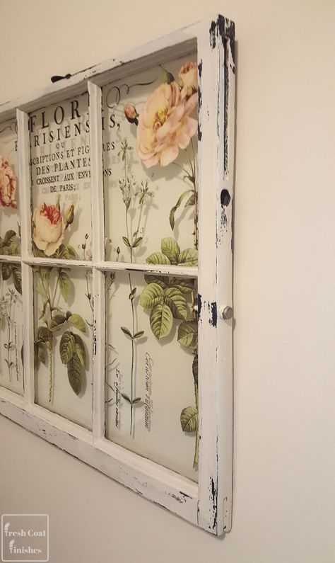 Vintage botanical window frame wall art with floral illustrations and distressed white paint, perfect for rustic decor.