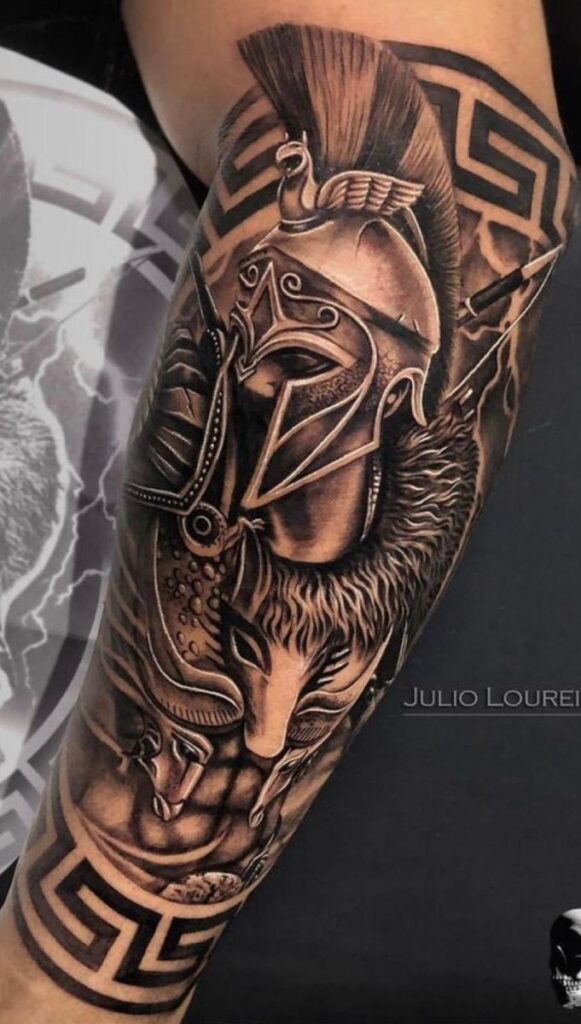 Intricate tattoo on arm featuring a detailed Spartan warrior helmet, Greek meander patterns, and a fierce wolf design.