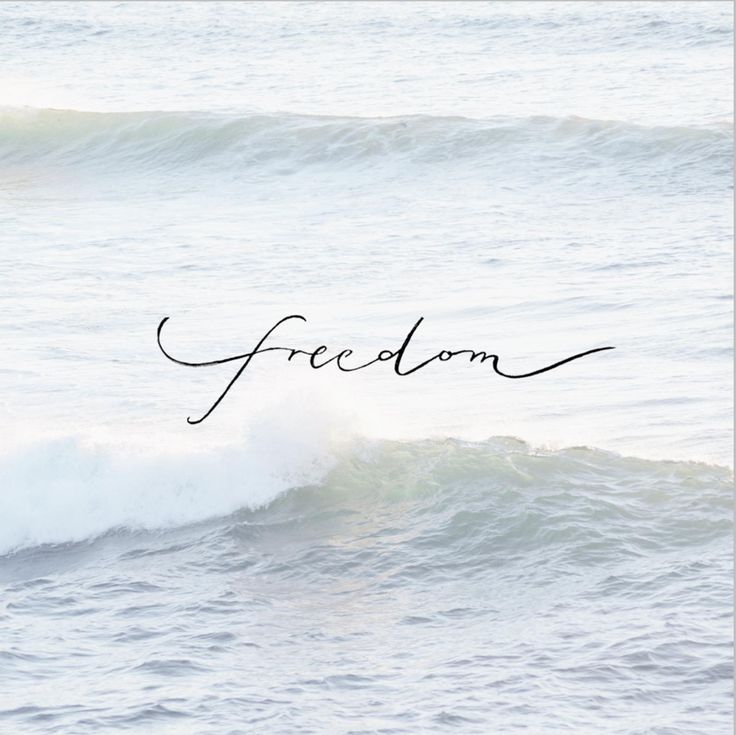 Ocean waves with 'freedom' text; serene seascape image symbolizing liberty, calmness, and tranquility.