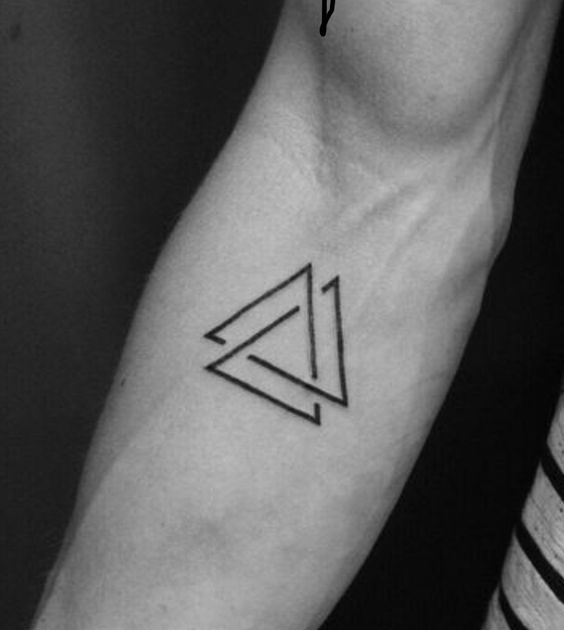 Minimalist geometric tattoo of interlocking triangles on an inner forearm, showcasing modern and clean linework.