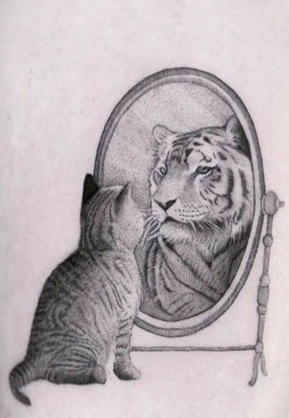 Tattoo of a cat looking into a mirror and seeing a tiger reflection, symbolizing self-perception and inner strength.