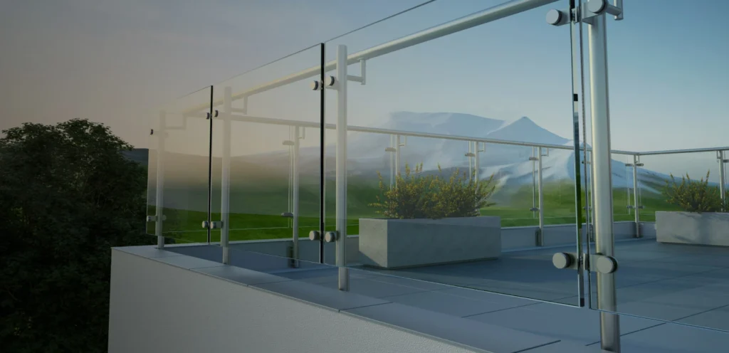 Modern glass balcony railing with scenic mountain view and green landscape; architectural exterior detail.