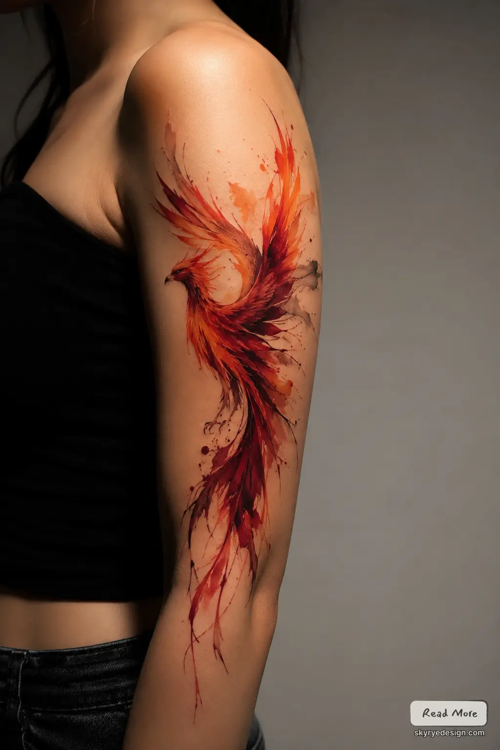 Watercolor Phoenix Watercolor phoenix tattoo in red-orange tones on woman's upper arm, abstract fiery wings and flowing tail | Sky Rye Design Watercolor phoenix tattoo in red-orange tones on woman's upper arm, abstract fiery wings and flowing tail