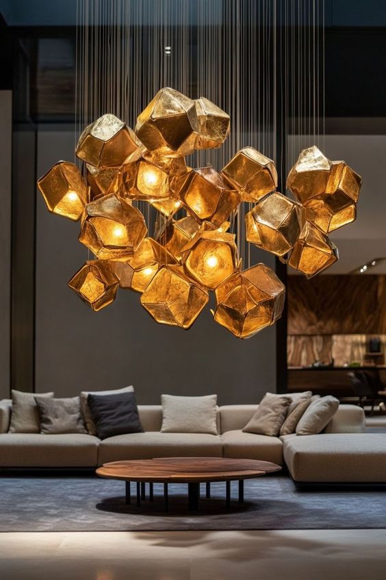 Modern living room with a geometric gold chandelier, beige sectional sofa, and round wooden coffee table for a stylish ambiance.