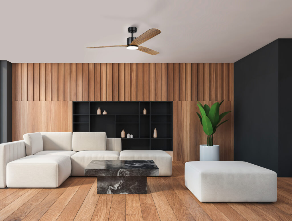 Modern living room with wooden accents, white sectional sofa, black marble coffee table, large plant, and minimalist decor.