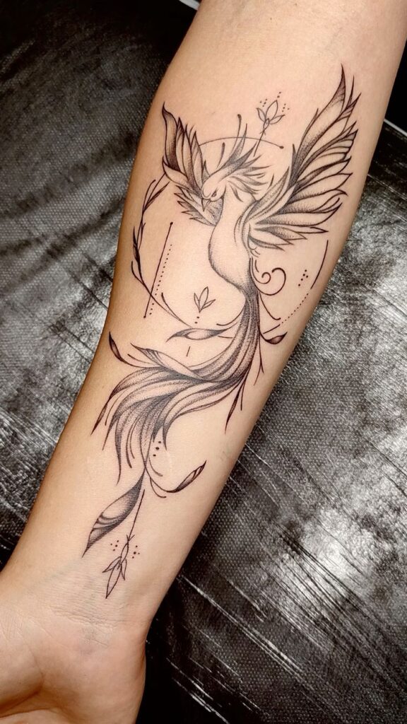 Intricate phoenix tattoo design on forearm, featuring detailed feathers, flowing lines, and a minimalistic style.