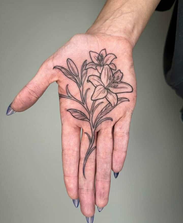 _ 4 Hand with detailed lily flower tattoo. Intricate black line art design covering the entire palm, showcasing artistic tattoo work. | Sky Rye Design Hand with detailed lily flower tattoo. Intricate black line art design covering the entire palm, showcasing artistic tattoo work.