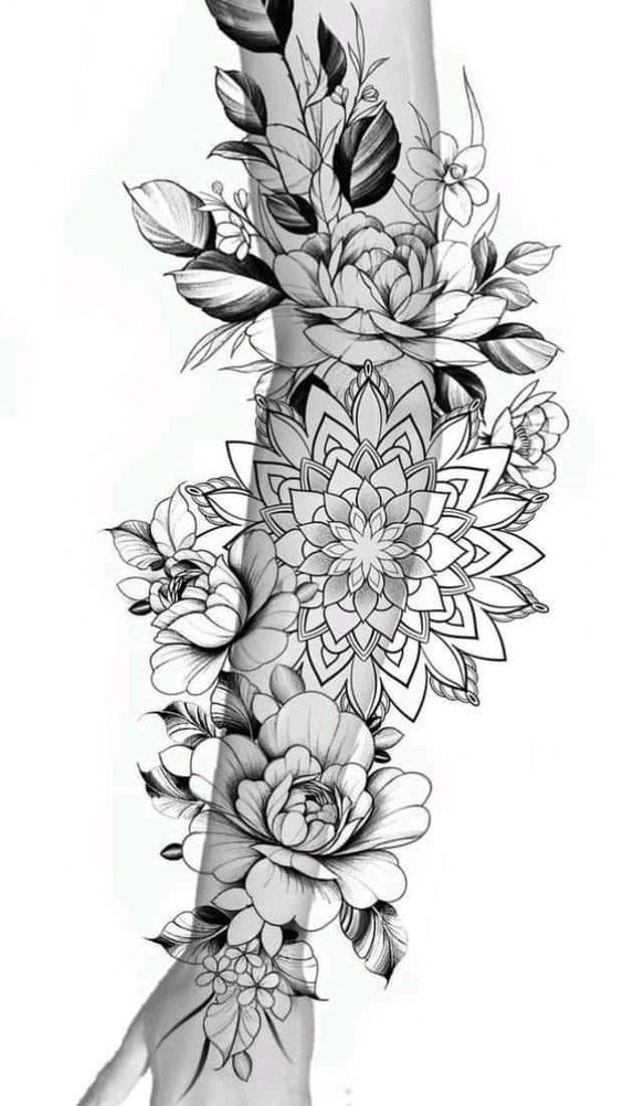 Detailed floral tattoo design featuring intricate flowers and leaves covering an individual's leg, black and white ink.