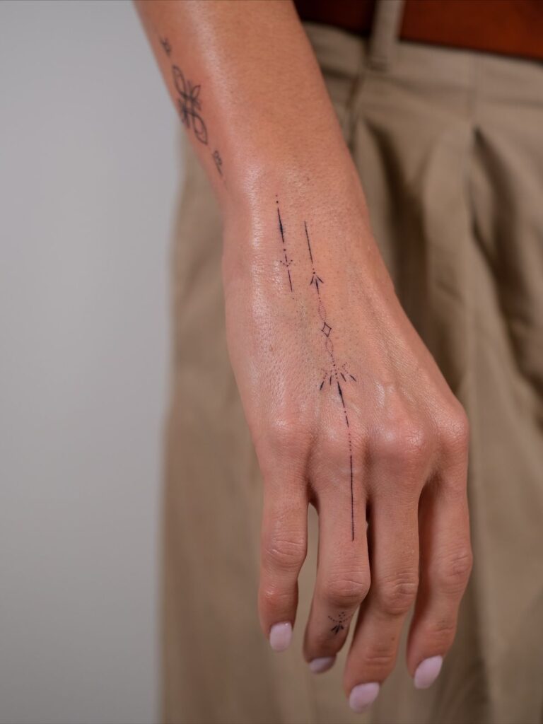 9174dc6a5dd4257a1daaef620e9726cd Minimalist line tattoos on a woman's hand, featuring abstract and geometric designs for a modern and stylish look. | Sky Rye Design Minimalist line tattoos on a woman's hand, featuring abstract and geometric designs for a modern and stylish look.