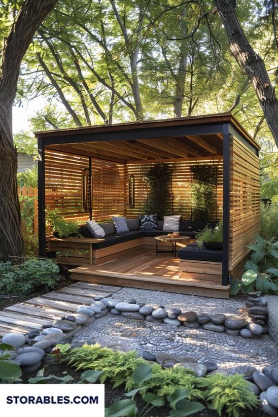 Modern outdoor wooden gazebo with cozy seating and lush greenery, perfect for relaxation and enjoying nature's beauty.