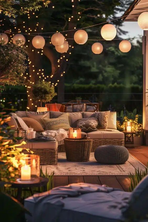 Cozy outdoor patio with string lights, lanterns, and comfortable seating, perfect for evening relaxation and gatherings.