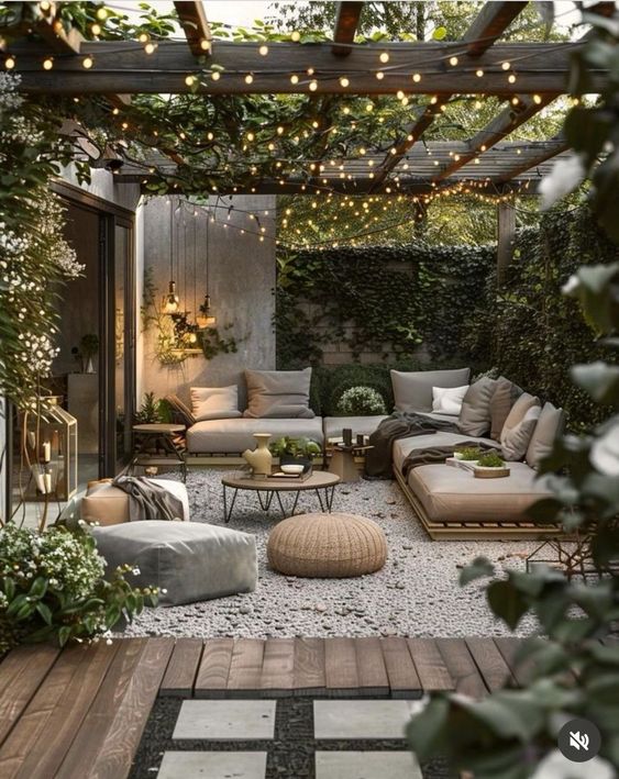 Beautiful outdoor patio with comfy seating, string lights, and lush greenery creating a cozy and inviting atmosphere.