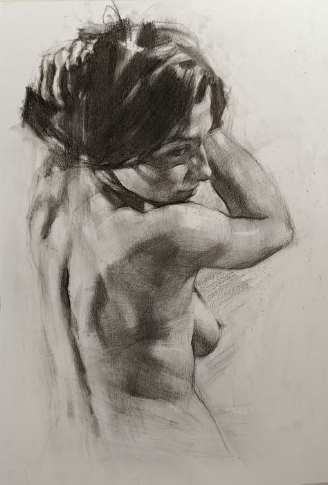 Charcoal drawing of a nude woman from behind, showing detailed shading and texture on her back and hair, in an art study.