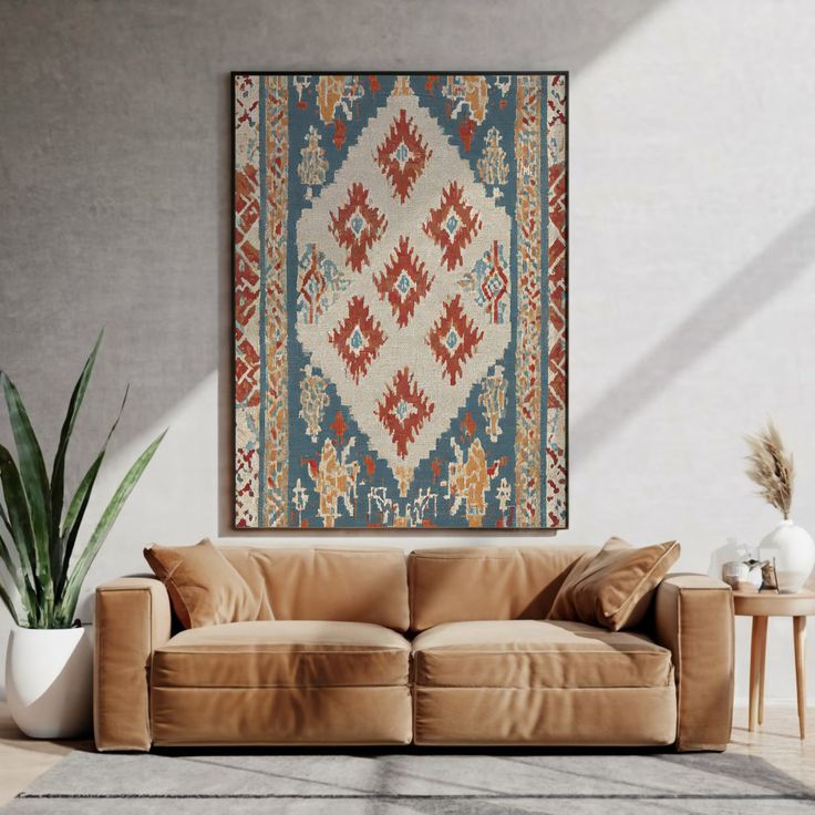 Stylish living room with beige couch, large patterned rug wall art, indoor plant, and modern decor elements bathed in sunlight.