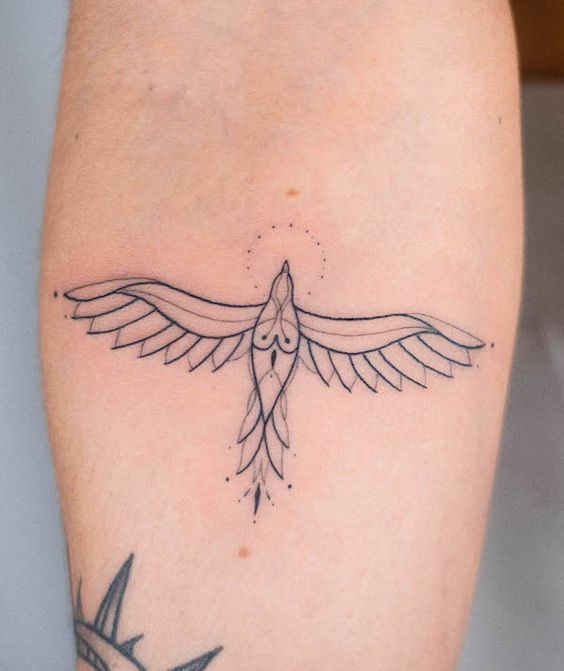 Minimalist flying bird tattoo design with spread wings on a forearm. Fine line ink artwork with geometric elements.