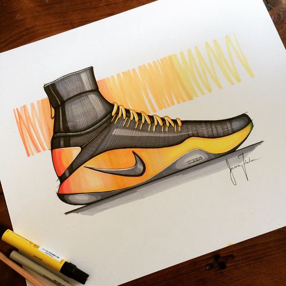 Sketch of a high-top Nike sneaker with black, yellow, and orange accents, and a Nike logo, on a wooden table with markers.