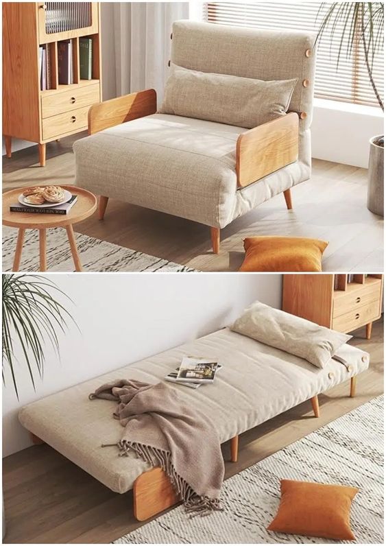 Modern beige armchair transforming into a bed in a cozy living room with wooden furniture and orange cushions.