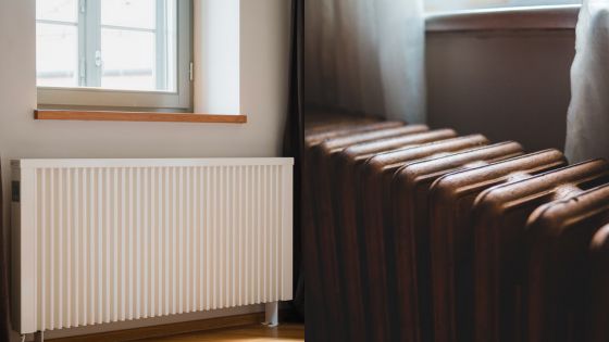 Modern white radiator next to a window, and a close-up of an old-fashioned radiator under a window with curtains.