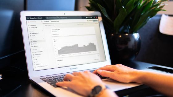 Person analyzing website traffic on Google Search Console on a laptop, enhancing SEO for better online visibility.