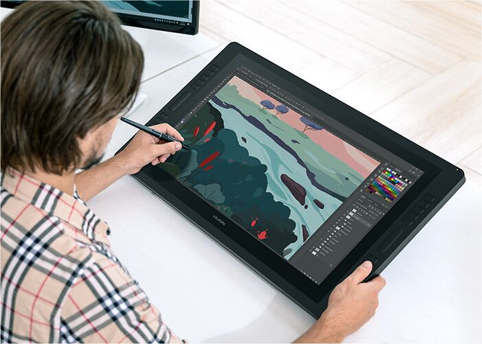 Digital artist drawing on a tablet with a stylus, creating colorful artwork using a graphic design software program.